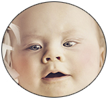 baby lying on a blanket cut away from the original photo by using a custom brush instead of the photoshop pen tool
